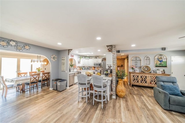 1181 W Westmont Ave, Hemet, CA 92543 - dining area with light wood-type flooring, recessed lighting, a chandelier, and arched walkways