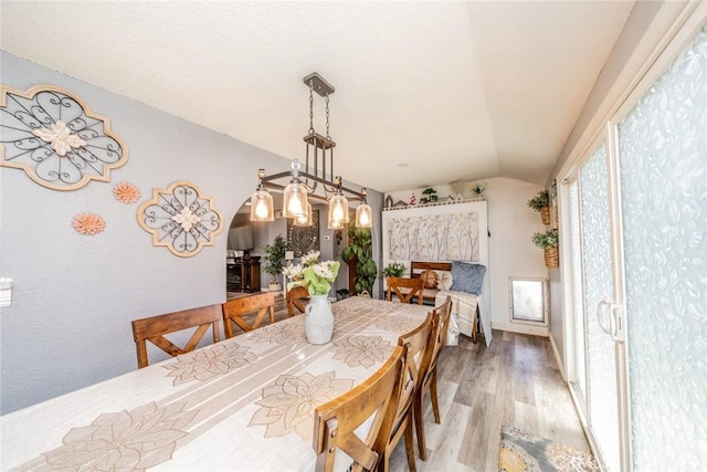 1181 W Westmont Ave, Hemet, CA 92543 - dining space featuring vaulted ceiling, wood finished floors, and arched walkways