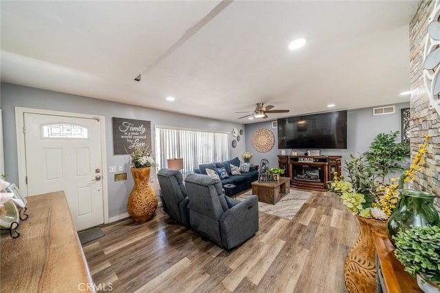 1181 W Westmont Ave, Hemet, CA 92543 - living room featuring a fireplace, ceiling fan, light wood-type flooring, recessed lighting, and healthy amount of natural light