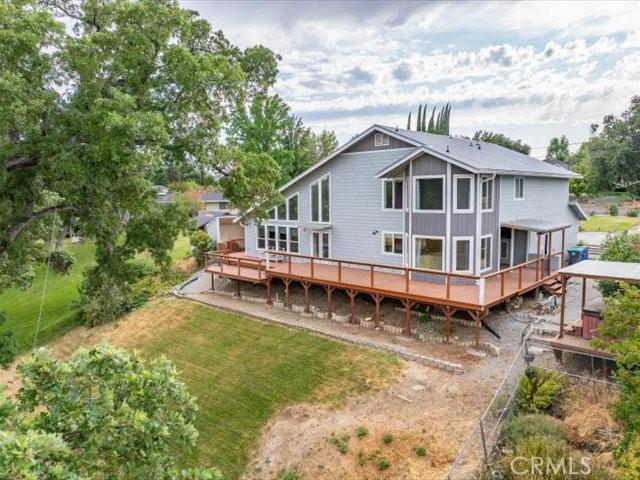 15540 China Rpds, Red Bluff, CA 96080 - rear view of house featuring a wooden deck, a yard, and board and batten siding