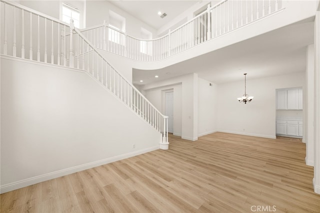 3959 Grandview Dr, Brea, CA 92823 - unfurnished living room featuring a chandelier, light wood finished floors, stairway, a towering ceiling, and recessed lighting