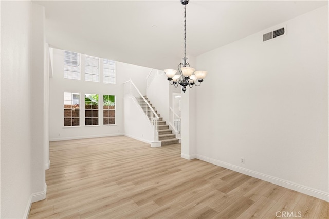 3959 Grandview Dr, Brea, CA 92823 - unfurnished living room featuring stairs, a chandelier, and light wood-type flooring
