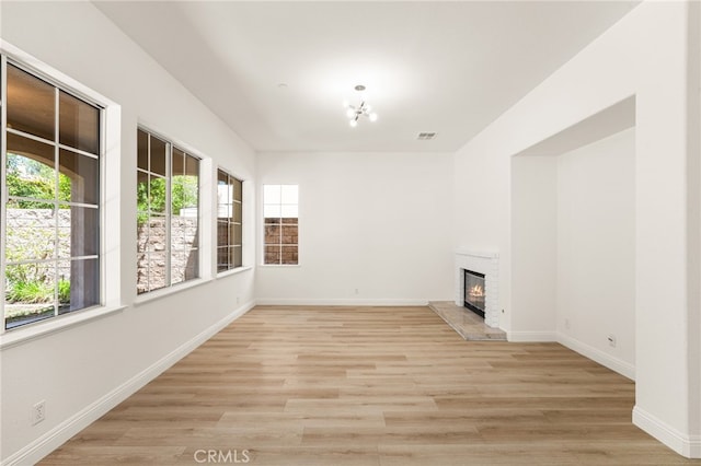 3959 Grandview Dr, Brea, CA 92823 - unfurnished living room with a glass covered fireplace, light wood-style flooring, and a chandelier