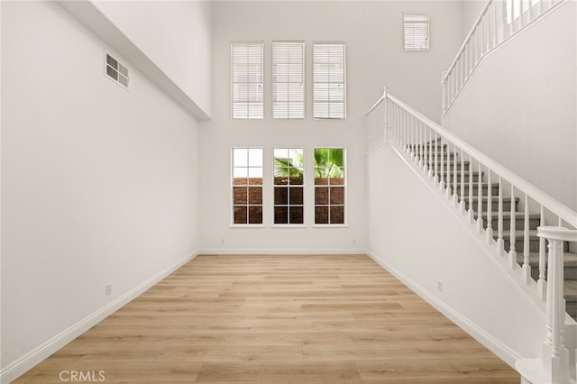 3959 Grandview Dr, Brea, CA 92823 - unfurnished living room with stairway, wood finished floors, and a high ceiling
