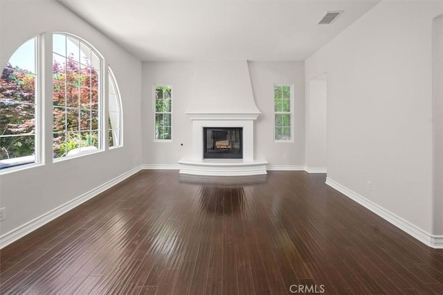24711 Tiburon St, Valencia, CA 91355 - unfurnished living room with plenty of natural light, a large fireplace, and dark wood-type flooring