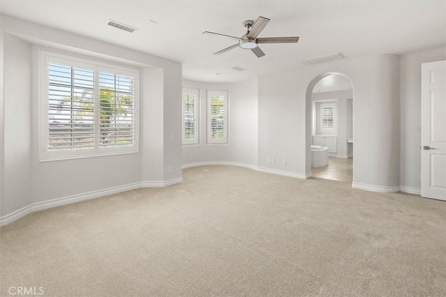 24711 Tiburon St, Valencia, CA 91355 - empty room with light carpet, a ceiling fan, and arched walkways