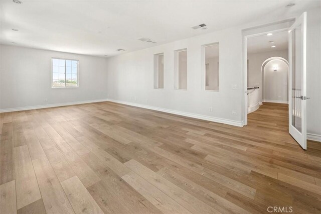 24711 Tiburon St, Valencia, CA 91355 - unfurnished room with light wood-type flooring and arched walkways