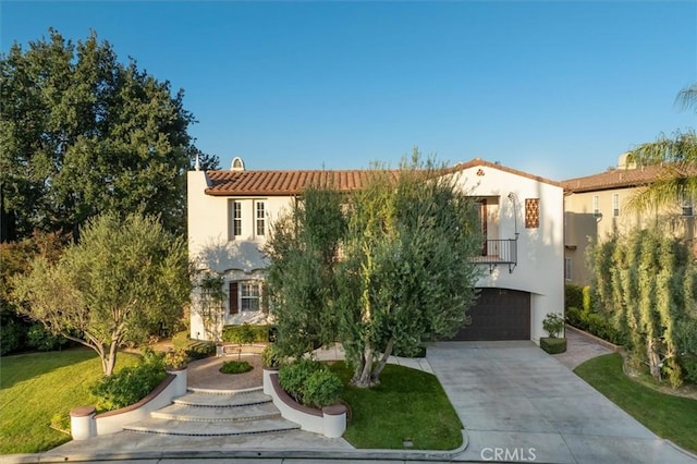 24711 Tiburon St, Valencia, CA 91355 - mediterranean / spanish-style home with stucco siding, driveway, a tiled roof, and an attached garage