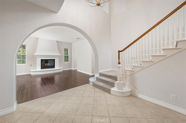 24711 Tiburon St, Valencia, CA 91355 - foyer entrance featuring tile patterned flooring, a high ceiling, stairway, and arched walkways
