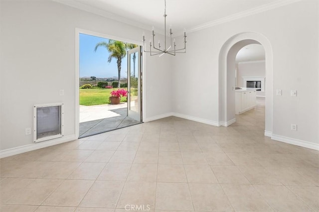 24711 Tiburon St, Valencia, CA 91355 - spare room with a chandelier, crown molding, arched walkways, and light tile patterned flooring
