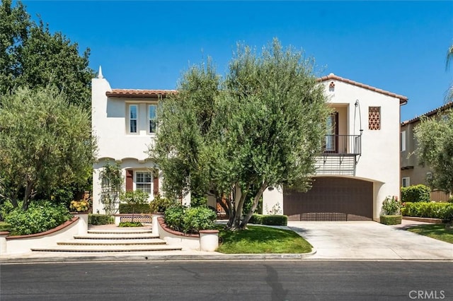 24711 Tiburon St, Valencia, CA 91355 - mediterranean / spanish home with concrete driveway, stucco siding, a garage, and a tiled roof