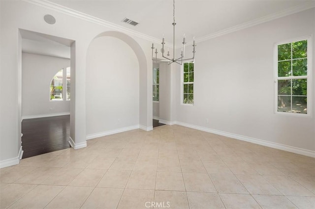 24711 Tiburon St, Valencia, CA 91355 - empty room with crown molding, arched walkways, light tile patterned flooring, and a chandelier