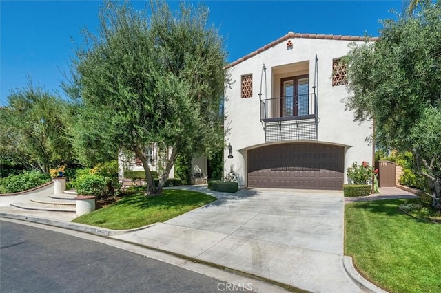 24711 Tiburon St, Valencia, CA 91355 - mediterranean / spanish home with concrete driveway, stucco siding, a garage, and a front lawn