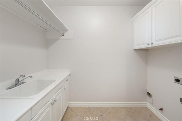 24711 Tiburon St, Valencia, CA 91355 - laundry room featuring electric dryer hookup, cabinet space, and light tile patterned floors