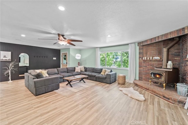 310 Teakwood Dr, Big Bear Lake, CA 92315 - living area featuring a wood stove, wood finished floors, recessed lighting, a ceiling fan, and arched walkways