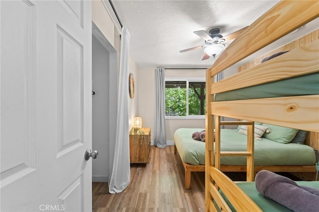 310 Teakwood Dr, Big Bear Lake, CA 92315 - bedroom featuring wood finished floors, a textured ceiling, and a ceiling fan