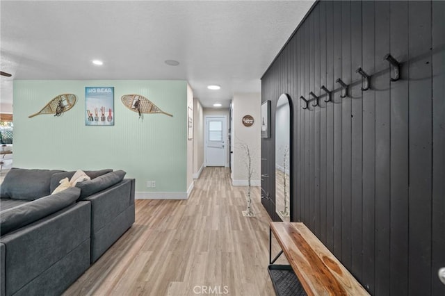 310 Teakwood Dr, Big Bear Lake, CA 92315 - living room featuring light wood-style floors, wood walls, arched walkways, and recessed lighting
