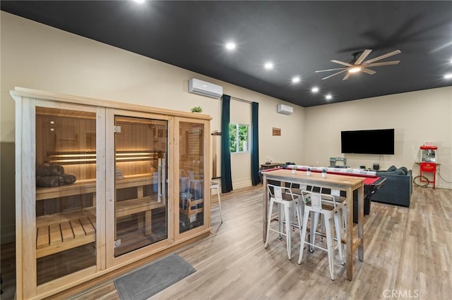 310 Teakwood Dr, Big Bear Lake, CA 92315 - recreation room with light wood-type flooring, a ceiling fan, a wall mounted AC, and recessed lighting