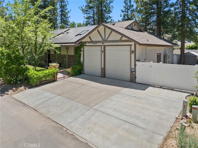 310 Teakwood Dr, Big Bear Lake, CA 92315 - view of front of property featuring stone siding, driveway, a gate, a garage, and roof with shingles