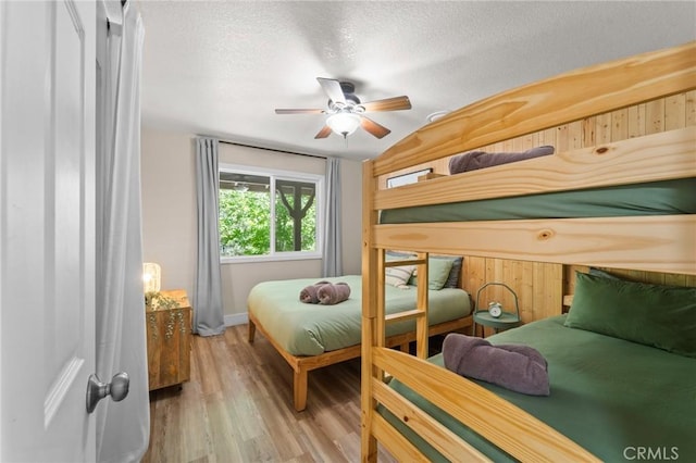 310 Teakwood Dr, Big Bear Lake, CA 92315 - bedroom with wood finished floors, a textured ceiling, and a ceiling fan
