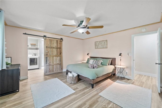 310 Teakwood Dr, Big Bear Lake, CA 92315 - bedroom with a barn door, wood finished floors, and ceiling fan