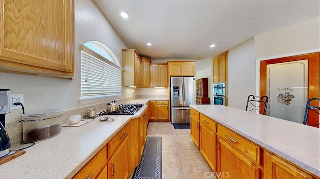 12443 Bannock Dr, Apple Valley, CA 92308 - kitchen with stainless steel appliances, light countertops, recessed lighting, and light tile patterned floors
