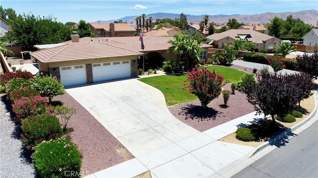 12443 Bannock Dr, Apple Valley, CA 92308 - ranch-style home with a tiled roof, concrete driveway, an attached garage, a chimney, and a front yard