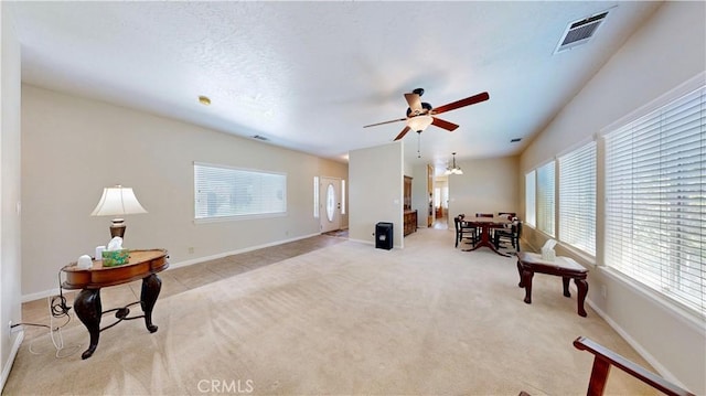 12443 Bannock Dr, Apple Valley, CA 92308 - living area with plenty of natural light, ceiling fan, and light carpet