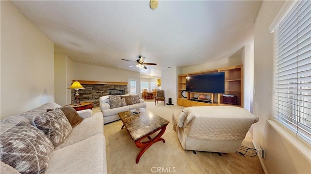 12443 Bannock Dr, Apple Valley, CA 92308 - living room featuring light carpet, a ceiling fan, and a fireplace
