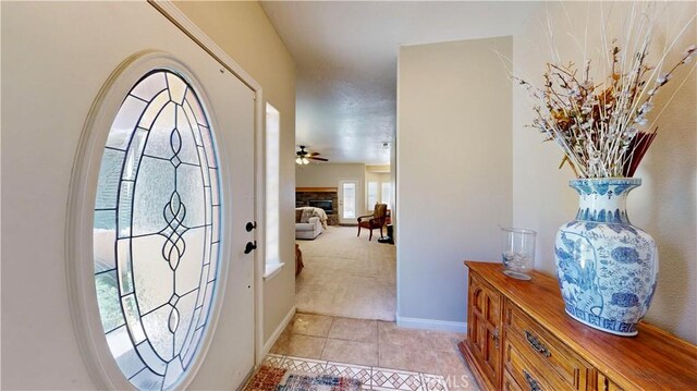 12443 Bannock Dr, Apple Valley, CA 92308 - foyer entrance featuring light tile patterned flooring, light colored carpet, and a glass covered fireplace
