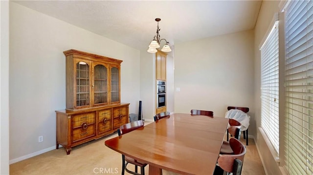 12443 Bannock Dr, Apple Valley, CA 92308 - dining space with light colored carpet, healthy amount of natural light, and a chandelier