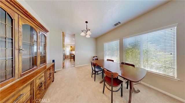 12443 Bannock Dr, Apple Valley, CA 92308 - dining area with light colored carpet and a chandelier