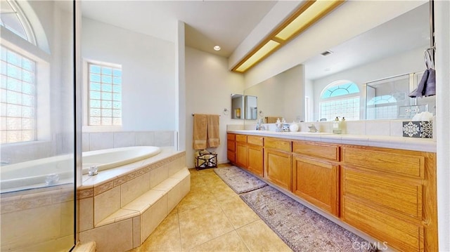 12443 Bannock Dr, Apple Valley, CA 92308 - full bathroom with double vanity, a garden tub, a shower stall, and tile patterned floors