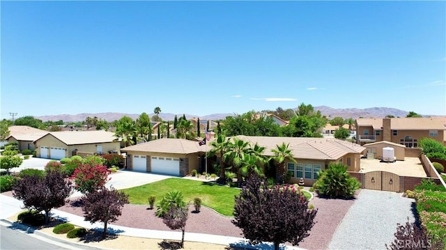 12443 Bannock Dr, Apple Valley, CA 92308 - ranch-style house featuring a residential view, a mountain view, a gate, and an attached garage