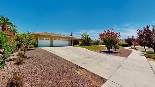 12443 Bannock Dr, Apple Valley, CA 92308 - view of front of home featuring driveway, an attached garage, and stone siding