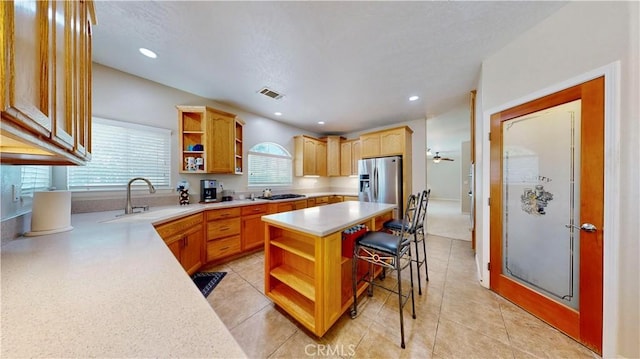 12443 Bannock Dr, Apple Valley, CA 92308 - kitchen featuring open shelves, light countertops, a kitchen bar, stainless steel appliances, and a kitchen island
