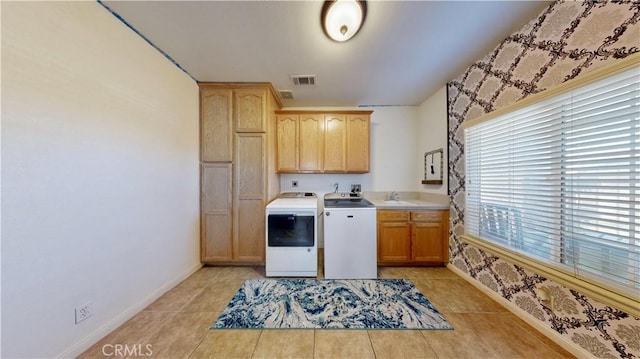 12443 Bannock Dr, Apple Valley, CA 92308 - laundry room with cabinet space, washing machine and clothes dryer, and light tile patterned floors