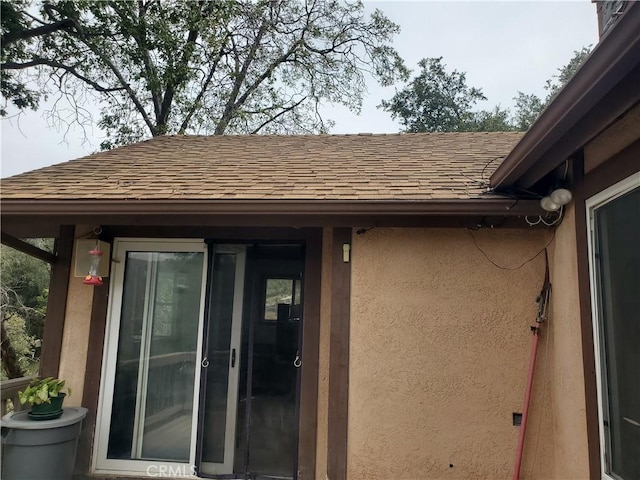 535 N Dart Canyon Rd, Crestline, CA 92325 - property entrance featuring a shingled roof and stucco siding