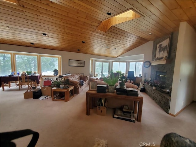 535 N Dart Canyon Rd, Crestline, CA 92325 - living area with carpet flooring, lofted ceiling, a stone fireplace, wood ceiling, and a skylight
