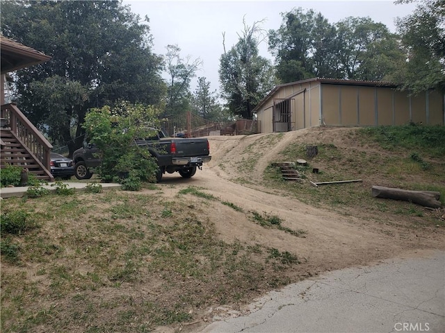 535 N Dart Canyon Rd, Crestline, CA 92325 - view of dirt / gravel road featuring stairs and a pole building