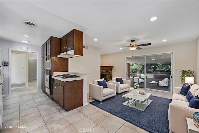 5347 E Bergh Dr, Anaheim Hills, CA 92807 - living room featuring recessed lighting, a ceiling fan, light tile patterned flooring, and a stone fireplace