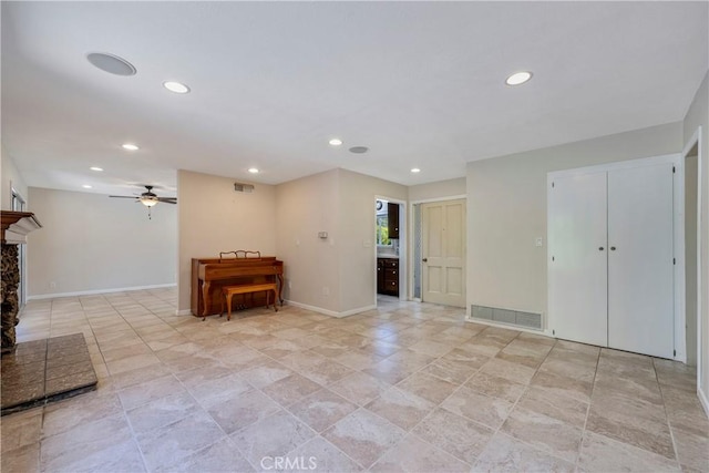 5347 E Bergh Dr, Anaheim Hills, CA 92807 - interior space featuring recessed lighting, a ceiling fan, a fireplace with raised hearth, and light stone finish flooring
