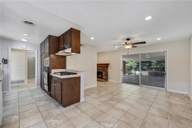 5347 E Bergh Dr, Anaheim Hills, CA 92807 - kitchen featuring dark brown cabinets, recessed lighting, ceiling fan, light tile patterned floors, and stainless steel gas cooktop