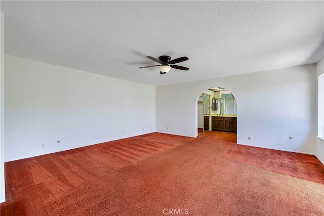 5347 E Bergh Dr, Anaheim Hills, CA 92807 - empty room with carpet, ceiling fan, arched walkways, and a textured ceiling