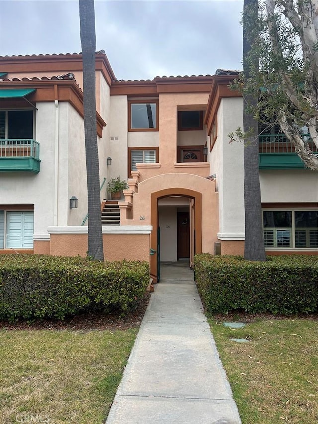 26 Villa Point Dr, Newport Beach, CA 92660 - view of front of property with stucco siding, a tile roof, and a front yard