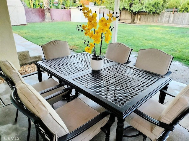 900 S Ann St, Tulare, CA 93274 - fenced backyard with outdoor dining area, a patio, and a storage unit
