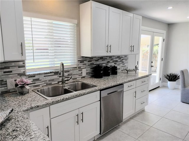 900 S Ann St, Tulare, CA 93274 - kitchen featuring stainless steel dishwasher, backsplash, light tile patterned flooring, and white cabinetry