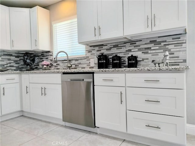 900 S Ann St, Tulare, CA 93274 - kitchen with dishwasher, white cabinetry, light stone countertops, tasteful backsplash, and light tile patterned floors