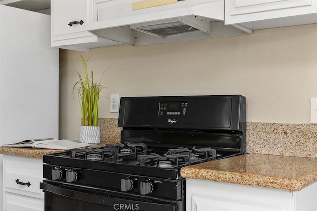 3746 Balboa Dr, Oceanside, CA 92056 - kitchen with black range with gas stovetop, under cabinet range hood, white cabinetry, and light stone countertops