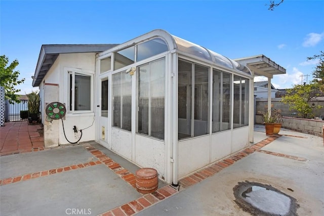 3746 Balboa Dr, Oceanside, CA 92056 - view of side of property with a sunroom, a patio, and stucco siding